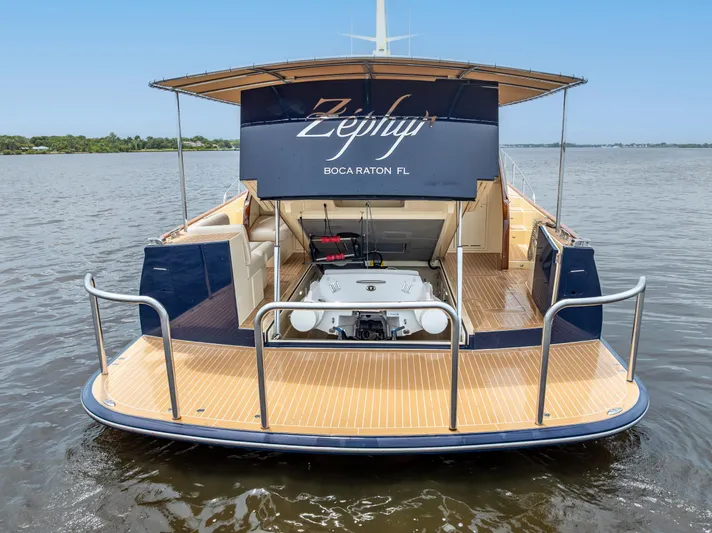 Zephyr Yacht Photos Pics 2018 Palm Beach Motor Yachts PB55, rear view on water, open storage compartment.