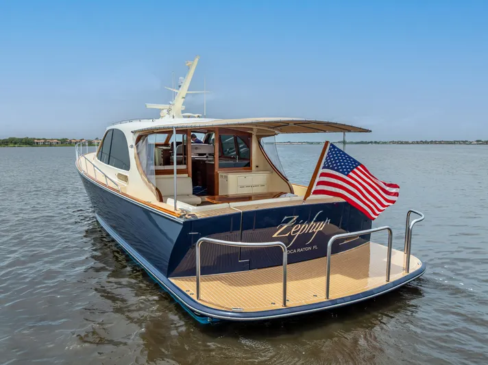 Zephyr Yacht Photos Pics 2018 Palm Beach Motor Yachts PB55 on water, American flag, elegant design.