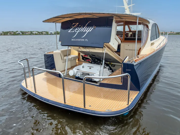 Zephyr Yacht Photos Pics 2018 Palm Beach Motor Yachts PB55, rear view, open engine compartment, docked on calm water.