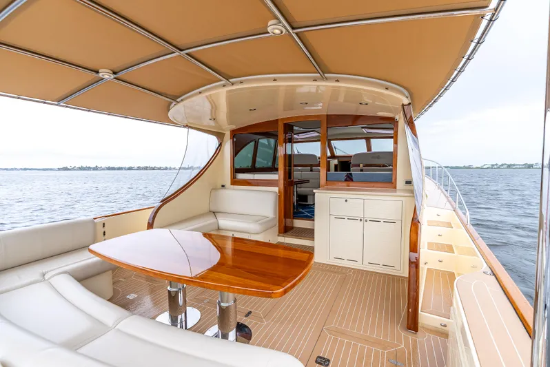 Zephyr Yacht Photos Pics Luxurious 2018 Palm Beach Motor Yachts PB55 with elegant deck and seating area on the water.