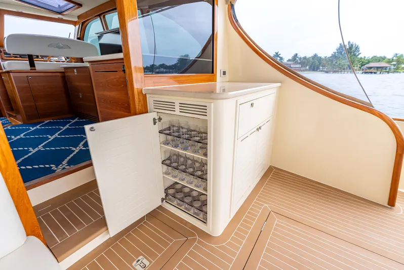 Zephyr Yacht Photos Pics Luxurious 2018 Palm Beach Motor Yachts PB55 interior with open cabinet and glassware.