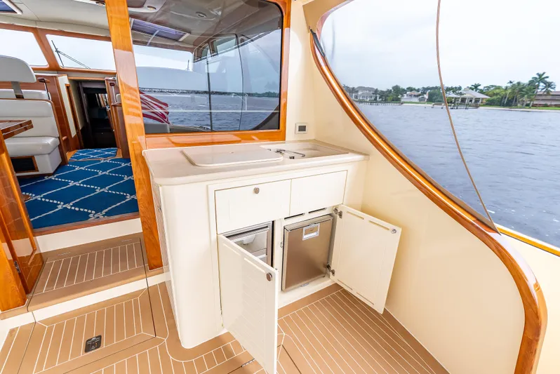 Zephyr Yacht Photos Pics 2018 Palm Beach Motor Yachts PB55 interior with kitchenette and scenic water view.