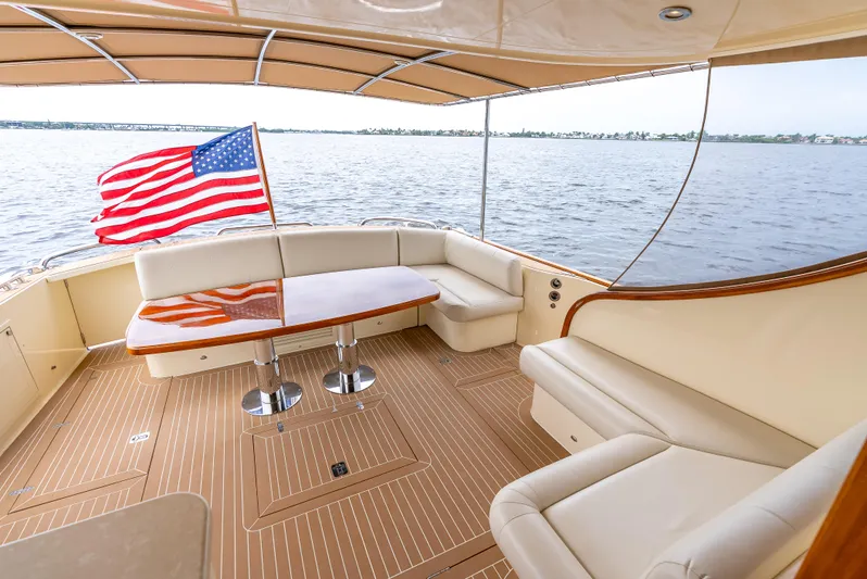 Zephyr Yacht Photos Pics Luxurious 2018 Palm Beach Motor Yachts PB55 with elegant seating and American flag on deck.
