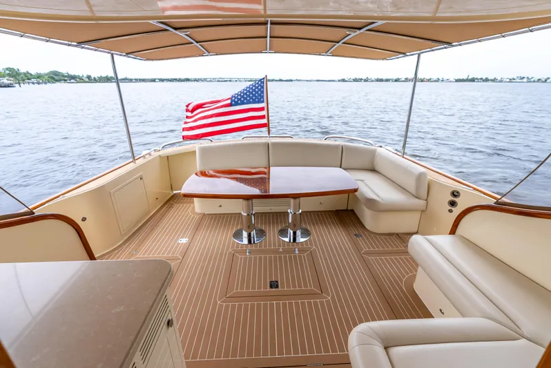 Zephyr Yacht Photos Pics Luxurious 2018 Palm Beach Motor Yachts PB55 deck with seating and American flag.