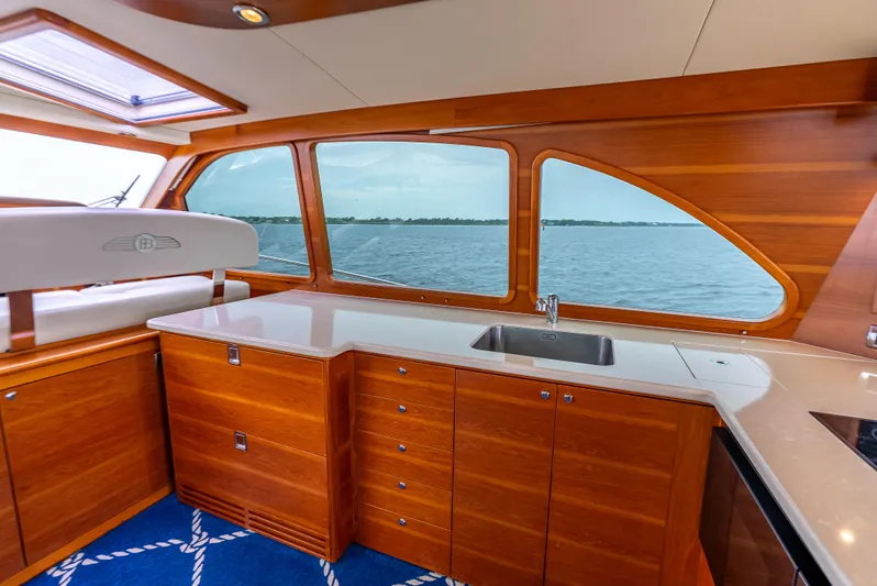 Zephyr Yacht Photos Pics Luxurious 2018 Palm Beach Motor Yachts PB55 interior with wooden cabinetry and ocean view.