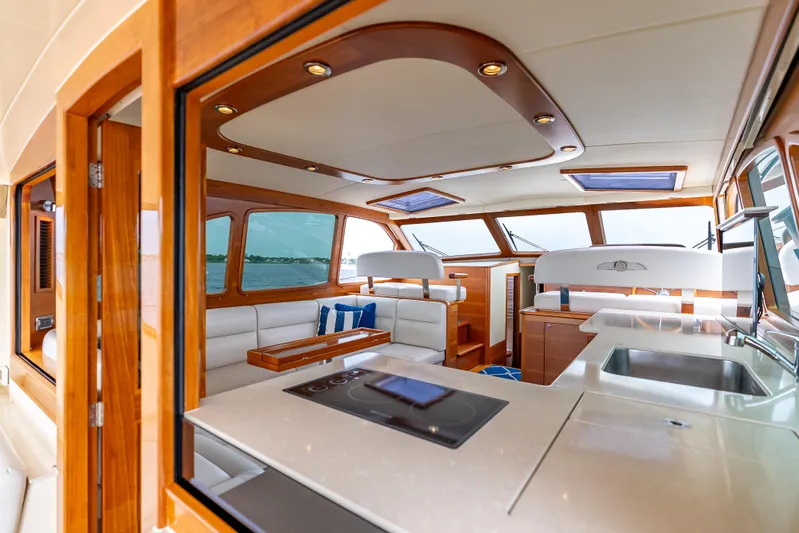 Zephyr Yacht Photos Pics Luxurious interior of 2018 Palm Beach Motor Yachts PB55, featuring elegant wood finishes and modern amenities.