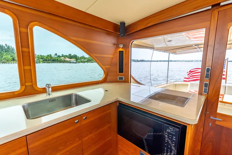 Zephyr Yacht Photos Pics Luxurious 2018 Palm Beach Motor Yachts PB55 interior with modern kitchen and scenic water view.