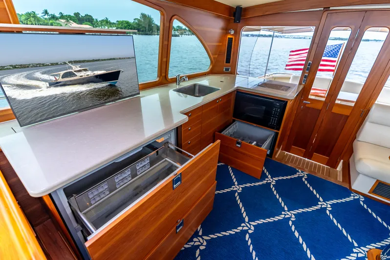 Zephyr Yacht Photos Pics Interior of 2018 Palm Beach Motor Yachts PB55, featuring modern kitchen and elegant wood finishes.