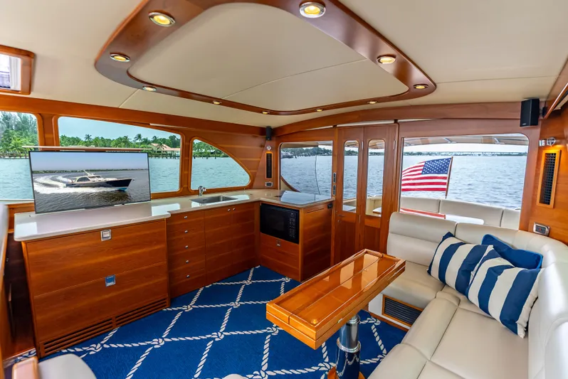 Zephyr Yacht Photos Pics Luxurious interior of 2018 Palm Beach Motor Yachts PB55 with elegant wood finish and scenic view.