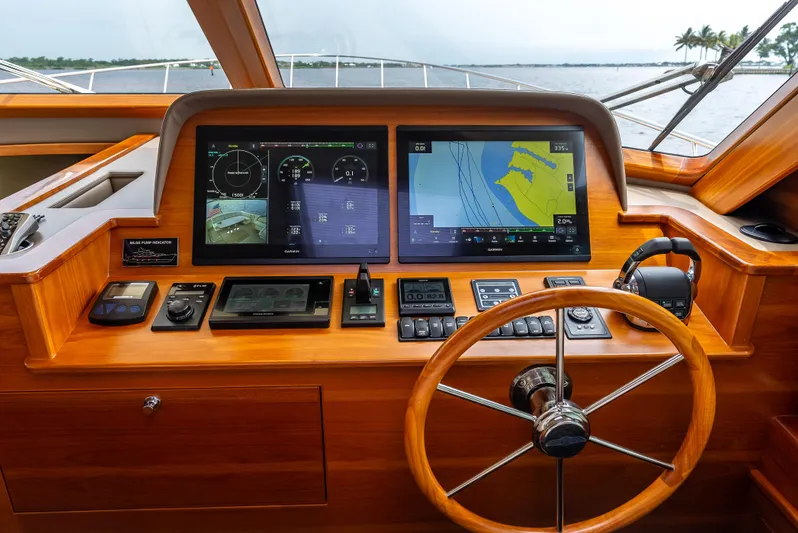 Zephyr Yacht Photos Pics Helm of 2018 Palm Beach Motor Yachts PB55 with navigation screens and wooden steering wheel.