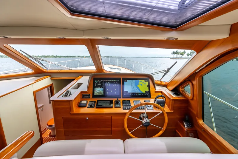 Zephyr Yacht Photos Pics 2018 Palm Beach Motor Yachts PB55 helm with navigation screens and wooden steering wheel.