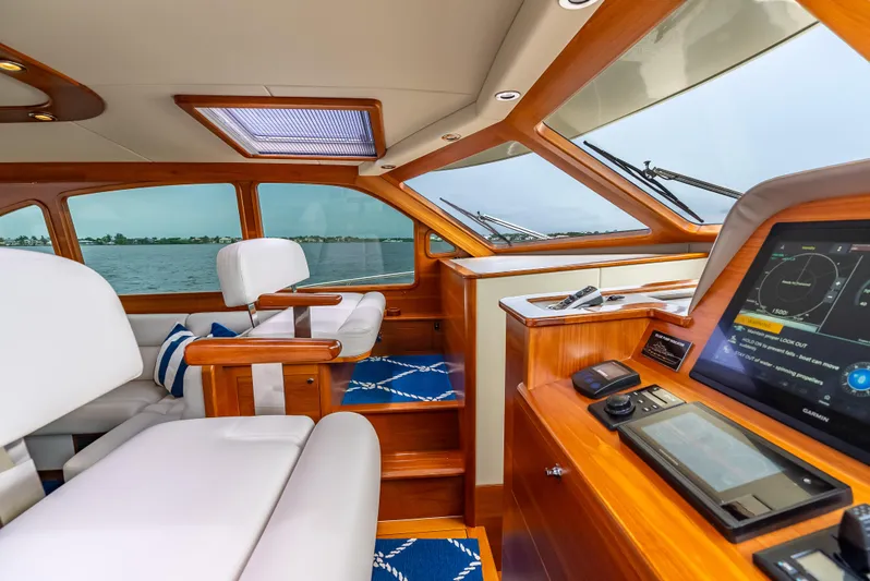 Zephyr Yacht Photos Pics Luxurious interior of 2018 Palm Beach Motor Yachts PB55, featuring elegant wood and modern navigation.