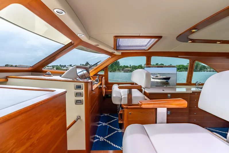 Zephyr Yacht Photos Pics Luxurious interior of 2018 Palm Beach Motor Yachts PB55 with elegant wood finish and scenic view.