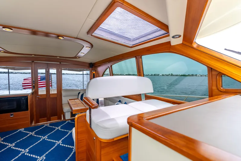 Zephyr Yacht Photos Pics Luxurious interior of 2018 Palm Beach Motor Yachts PB55 with elegant wood finish and ocean view.