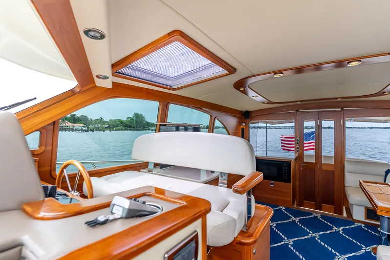 Zephyr Yacht Photos Pics Luxurious interior of 2018 Palm Beach Motor Yachts PB55, featuring elegant wood and leather finishes.