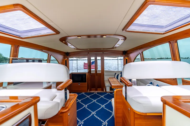 Zephyr Yacht Photos Pics Luxurious interior of 2018 Palm Beach Motor Yachts PB55 with elegant wood and white seating.