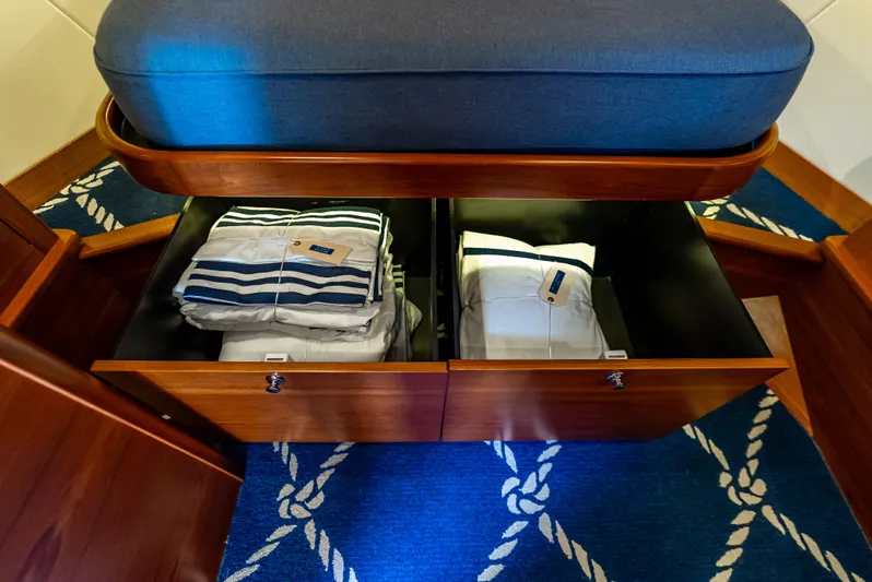 Zephyr Yacht Photos Pics Under-seat storage in 2018 Palm Beach Motor Yachts PB55, featuring neatly organized linens.