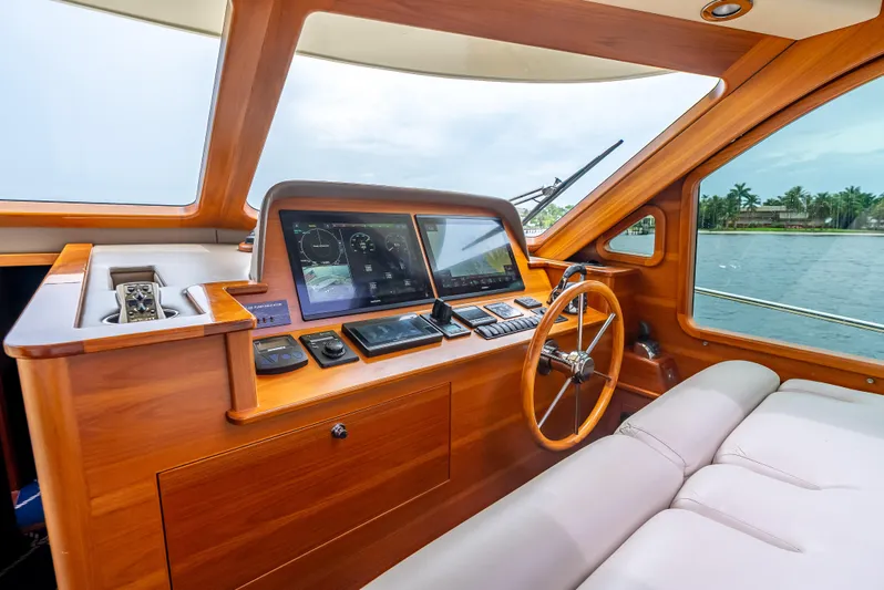 Zephyr Yacht Photos Pics 2018 Palm Beach Motor Yachts PB55 helm with wooden dashboard and modern navigation equipment.