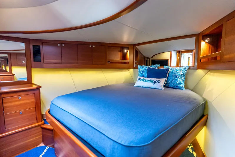 Zephyr Yacht Photos Pics Luxurious cabin interior of 2018 Palm Beach Motor Yachts PB55 with cozy bedding and wooden cabinetry.