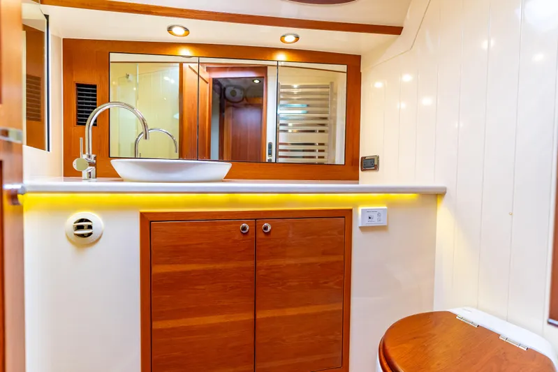 Zephyr Yacht Photos Pics Luxurious bathroom interior of 2018 Palm Beach Motor Yachts PB55 with wood accents.