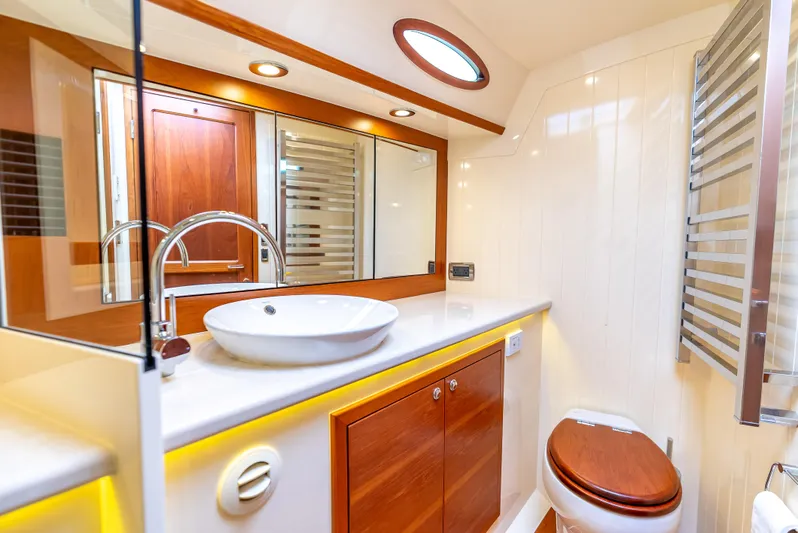 Zephyr Yacht Photos Pics Luxurious bathroom in 2018 Palm Beach Motor Yachts PB55, featuring modern fixtures and elegant wood accents.
