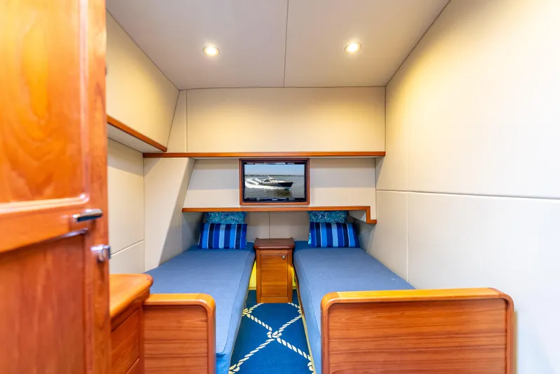 Zephyr Yacht Photos Pics Luxurious cabin interior of 2018 Palm Beach Motor Yachts PB55 with twin beds and nautical decor.