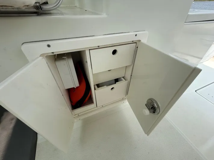 Good Sport Yacht Photos Pics Open storage compartment on 2011 Hydra-Sports 3000 VX boat, showing interior shelves and equipment.