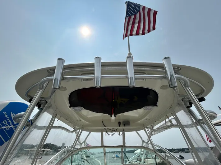 Good Sport Yacht Photos Pics 2011 Hydra-Sports 3000 VX boat with American flag, viewed from below under sunny sky.