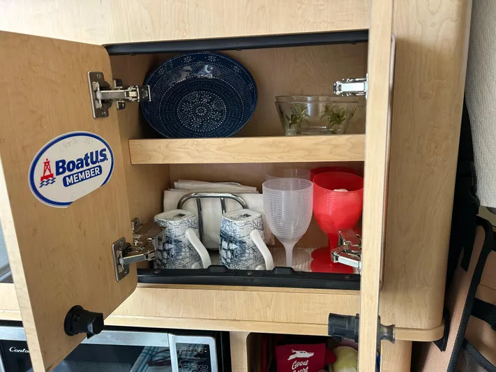 Good Sport Yacht Photos Pics Cabinet with dishes and glasses on a 2011 Hydra-Sports 3000 VX boat.