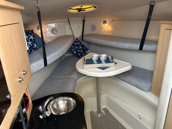 Good Sport Yacht Photos Pics 2011 Hydra-Sports 3000 VX cabin interior with cozy seating and table setup.