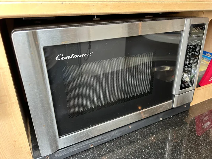 Good Sport Yacht Photos Pics Stainless steel Contoure microwave oven in a wooden kitchen cabinet.
