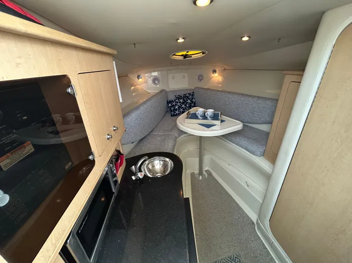 Good Sport Yacht Photos Pics 2011 Hydra-Sports 3000 VX cabin interior with kitchenette and cozy seating area.