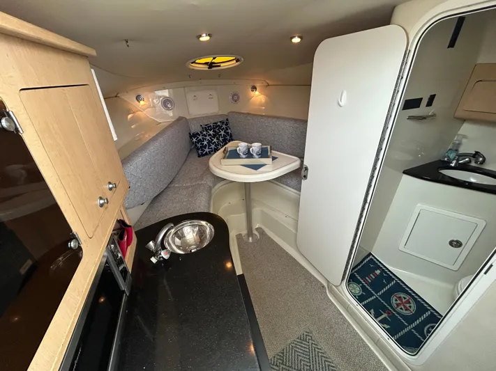 Good Sport Yacht Photos Pics 2011 Hydra-Sports 3000 VX cabin interior with kitchenette, seating area, and bathroom.