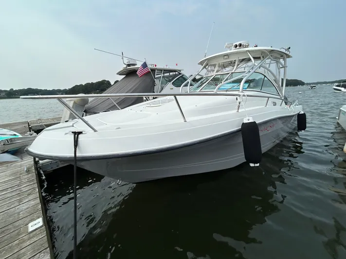 Good Sport Yacht Photos Pics 2011 Hydra-Sports 3000 VX boat docked on calm water, featuring sleek design and American flag.