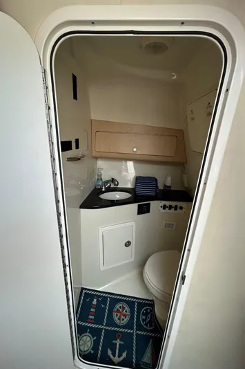 Good Sport Yacht Photos Pics 2011 Hydra-Sports 3000 VX boat bathroom with sink, toilet, and nautical-themed mat.