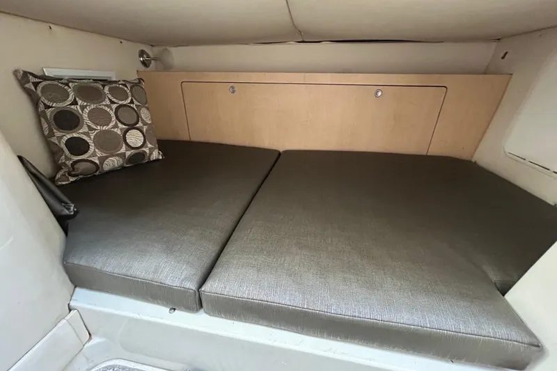 Good Sport Yacht Photos Pics 2011 Hydra-Sports 3000 VX cabin interior with cushioned seating and decorative pillow.