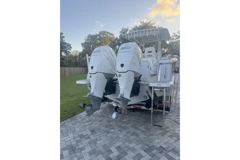  Yacht Photos Pics 2023 Southport 30 FE boat with dual outboard engines on a paved driveway.