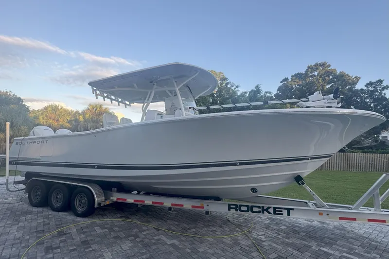  Yacht Photos Pics 2023 Southport 30 FE boat on a trailer, parked on a paved driveway.
