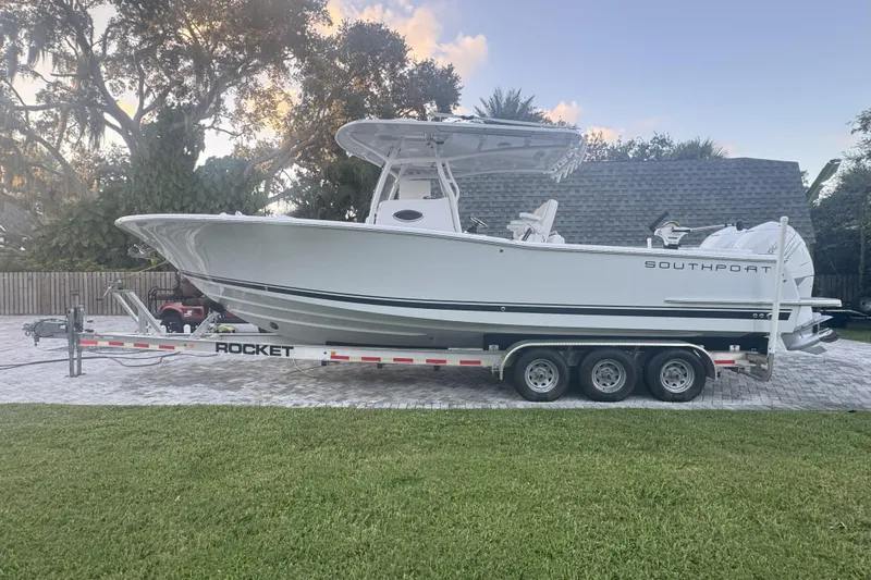  Yacht Photos Pics 2023 Southport 30 FE boat on a trailer, parked outdoors with trees in the background.