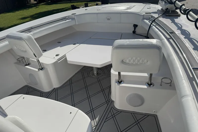  Yacht Photos Pics 2023 Southport 30 FE boat interior with seating and table, featuring modern design.