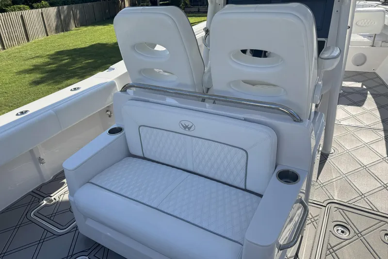  Yacht Photos Pics 2023 Southport 30 FE boat interior with white cushioned seating and cup holders.