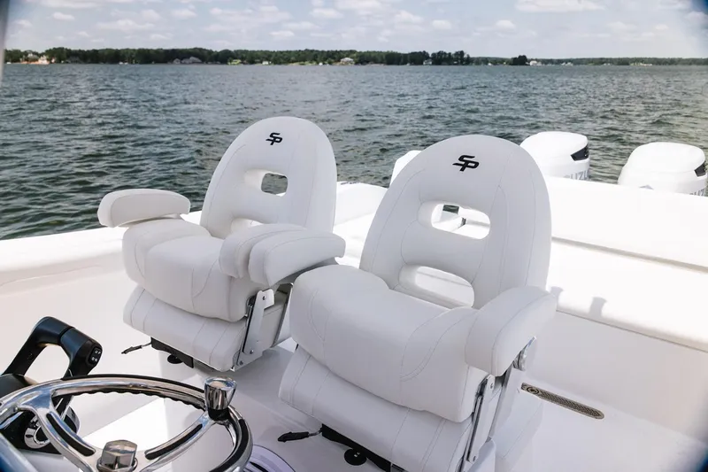  Yacht Photos Pics Manufacturer Provided Image: 2026 Sea Pro 265FLX Sandbar boat with luxurious white seating on a serene lake.