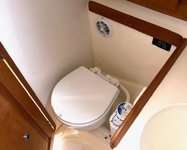 Force 10 Yacht Photos Pics Compact marine toilet in 2008 Tartan 3400 sailboat bathroom.