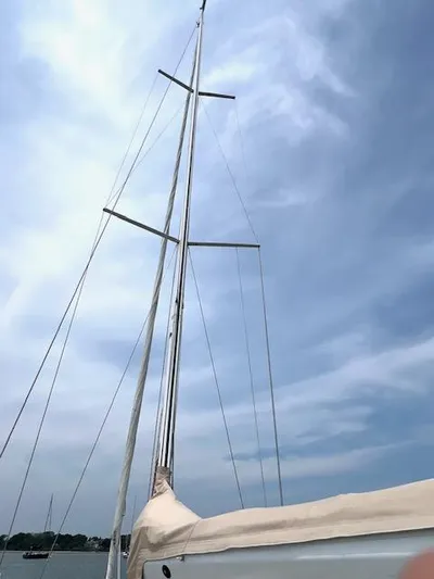 Force 10 Yacht Photos Pics Sailboat mast of 2008 Tartan 3400 against a cloudy sky.