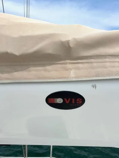 Force 10 Yacht Photos Pics Sailboat with beige cover and "Novis" logo, Tartan 3400, 2008 model.