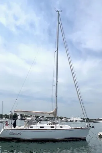 Force 10 Yacht Photos Pics Sailboat Tartan 3400, 2008 model, docked in a marina under a cloudy sky.