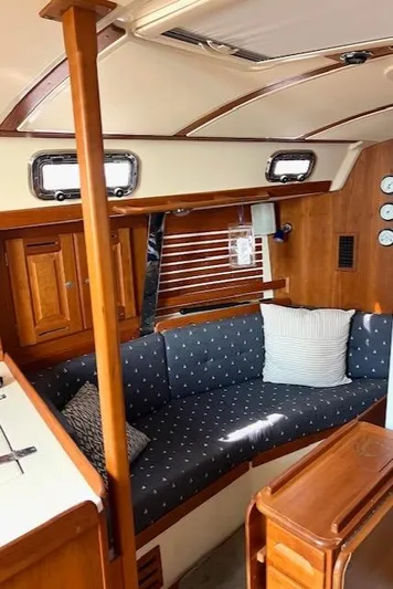 Force 10 Yacht Photos Pics Interior of 2008 Tartan 3400 sailboat with cozy seating and wooden cabinetry.
