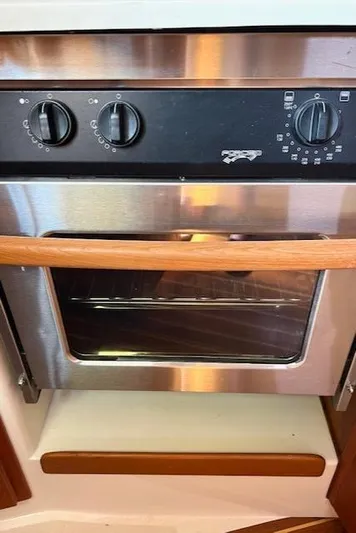 Force 10 Yacht Photos Pics Stainless steel oven with wooden handle in a 2008 Tartan 3400 yacht kitchen.