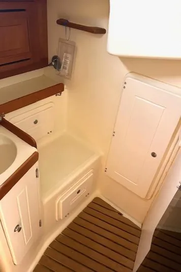 Force 10 Yacht Photos Pics Compact bathroom in 2008 Tartan 3400 yacht with wooden accents and storage cabinets.