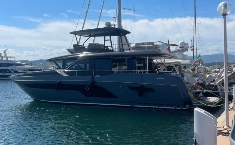  Yacht Photos Pics 2023 Prestige X60 yacht docked in a marina under a clear sky.